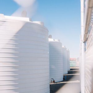 Line of four white Nu-Tank industrial tanks.