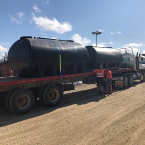 Two Nu-Tank Molasses Transport Tanks on the back of a truck.