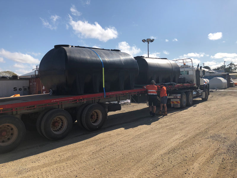 Two Nu-Tank Molasses Transport Tanks on the back of a truck.